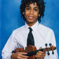 Brian Joseph's teenage-aged son Julian Joseph holding a violin against a blue background